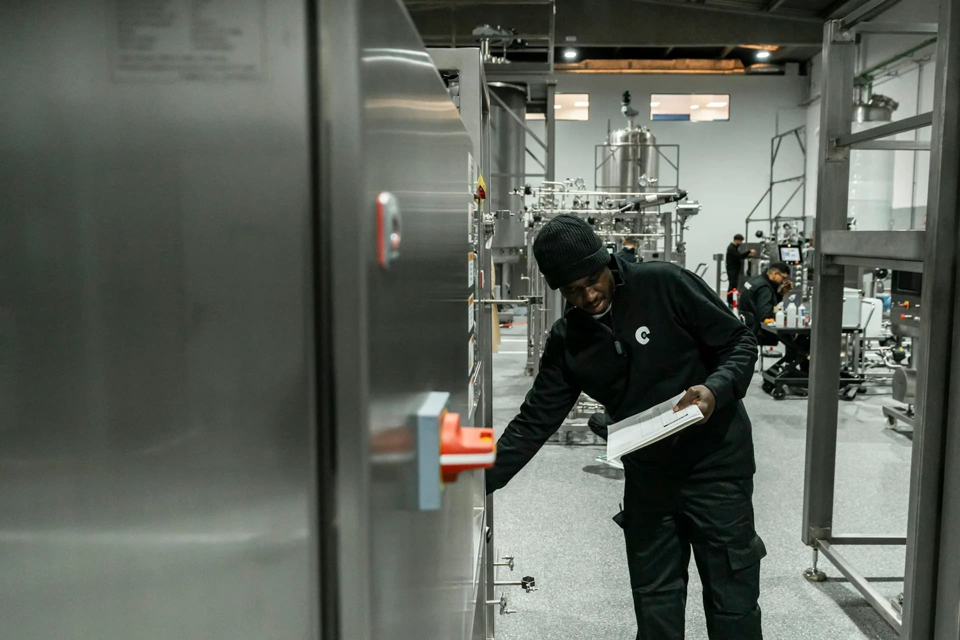 Technician inspecting manufacturing equipment