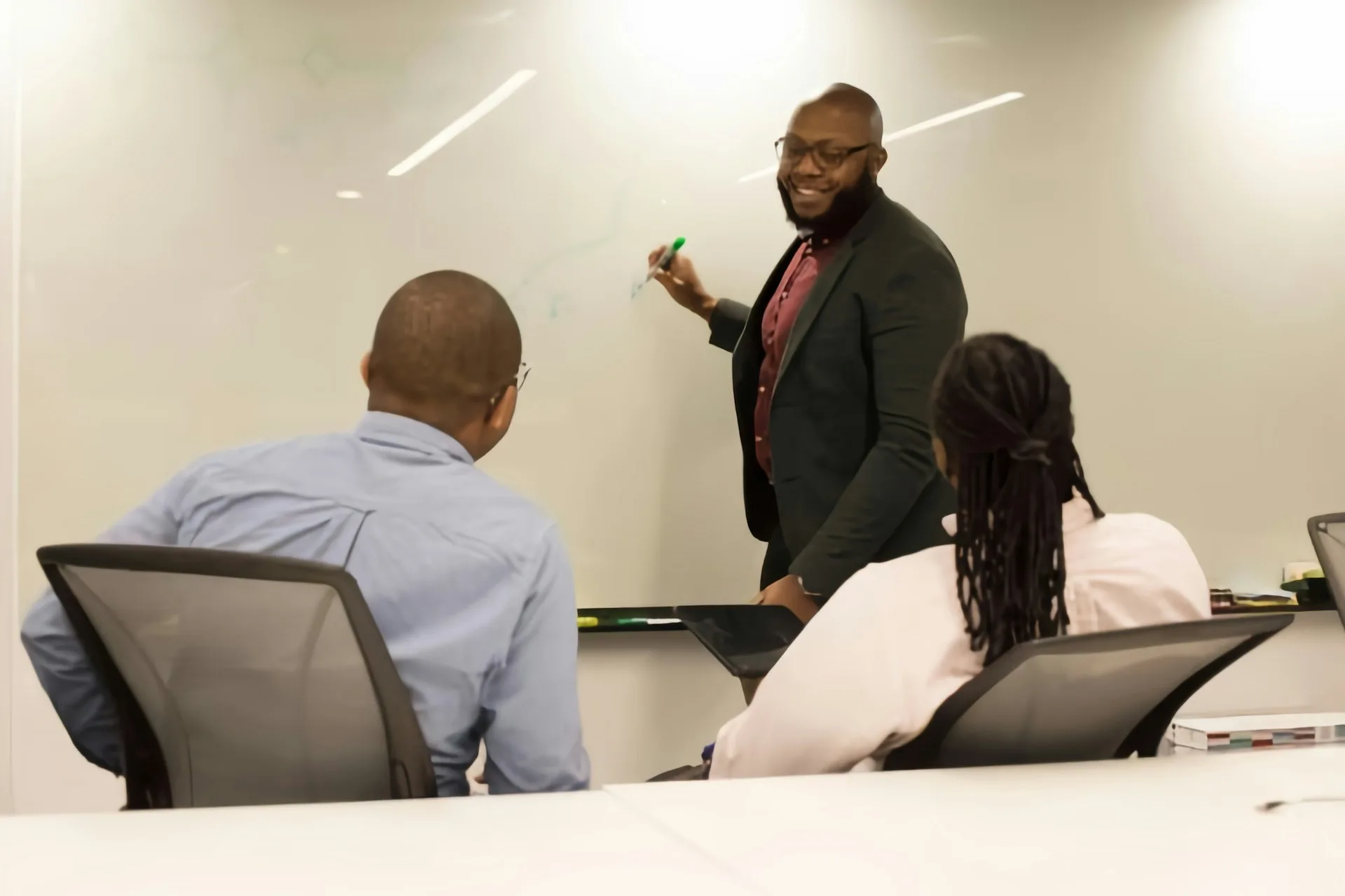 Engineer presenting technical advisory at a whiteboard